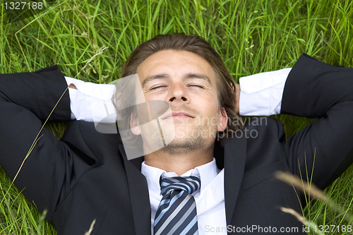 Image of Well-dressed young businessman is resting 