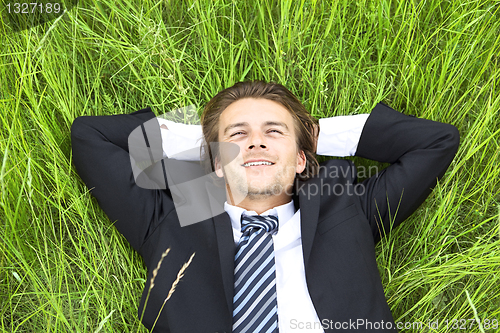 Image of Well-dressed young businessman is resting