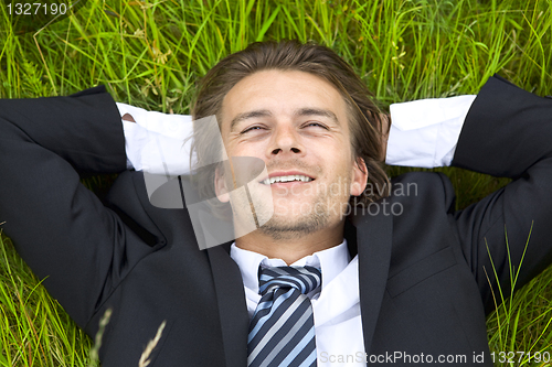 Image of Well-dressed young businessman is resting