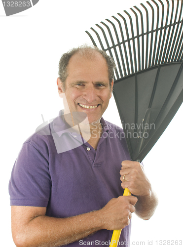 Image of middle age senior man holding garden leaf rake tool