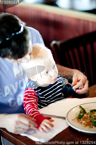 Image of father feeding his son