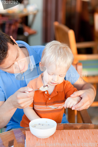Image of father and son having breakfast
