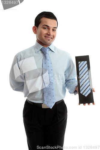 Image of Smiling salesman proudly with a product merchandise