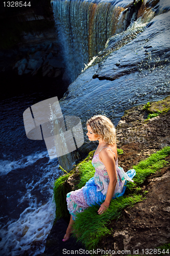 Image of beautiful girl on brink of river waterfalls