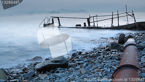 Image of old metal pipe and road to sea