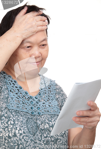 Image of Closeup portrait of smiling senior woman reading a book 