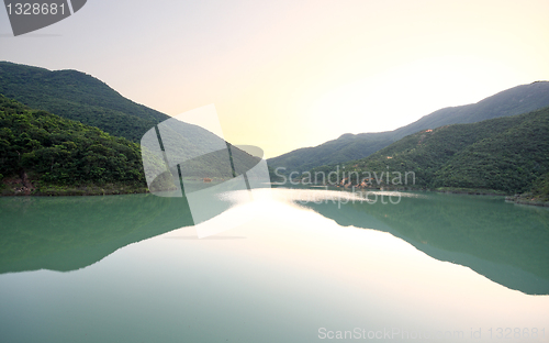Image of beautiful sunset over mountain lake