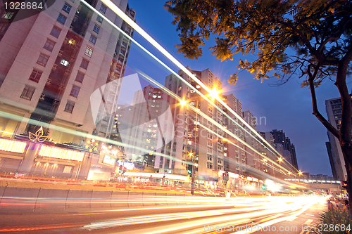 Image of traffic in downtown at sunset moment