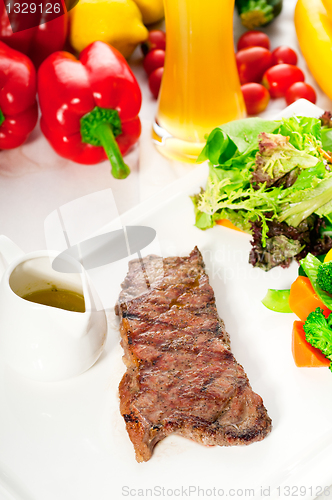 Image of juicy BBQ grilled rib eye ,ribeye steak and vegetables