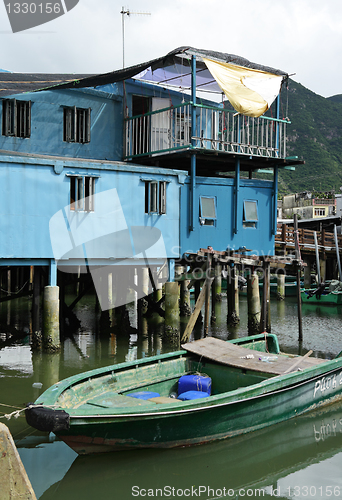Image of Tai O fishing village with stilt house and old boat