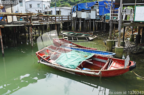 Image of Tai O fishing village with stilt house and old boat
