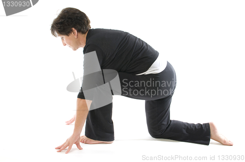 Image of middle age woman demonstrating yoga position Anjaneyasana Kneeli