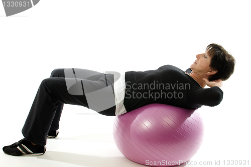 Image of woman using core training fitness ball for abdominal crunch sit-