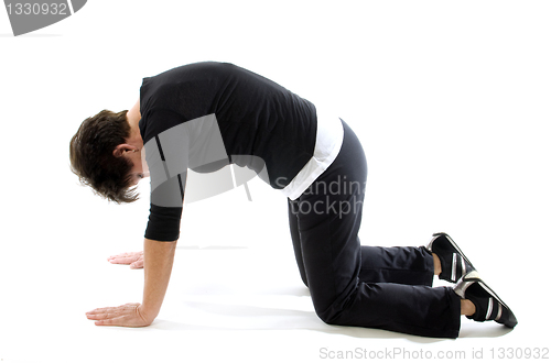 Image of woman doing yoga back press cat cow yoga position