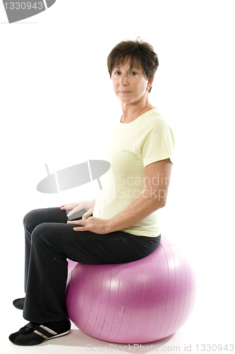 Image of woman using core training fitness ball exercising