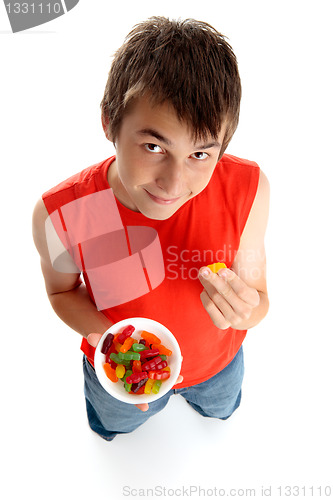 Image of Boy eating lollies