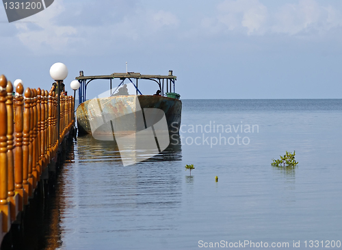 Image of Old boat tied to a jetty in Cuba