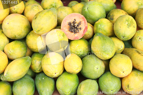 Image of Papaya fruit cut and whole. 