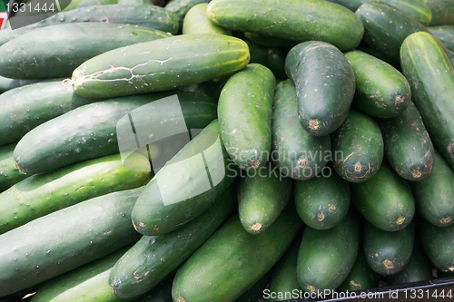 Image of cucumbers bunched together for sale at market good as a backgrou