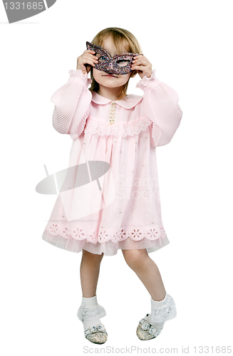 Image of little girl in a fancy mask in studio