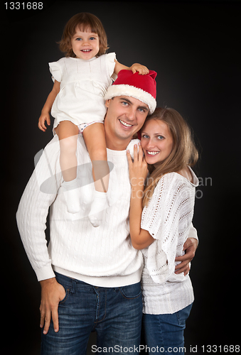 Image of Father in santa hat holding little girl on his shoulder and hugg