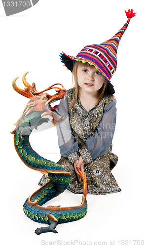 Image of little girl sitting on the floor in the studio with a decorative