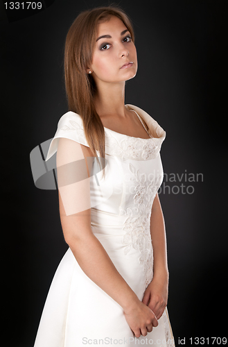 Image of beautiful girl in a wedding dress in the studio
