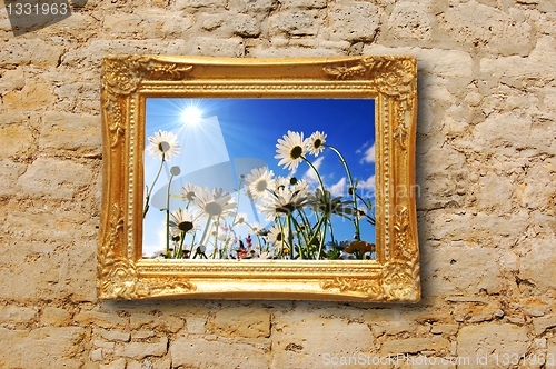 Image of flowers and image frame on wall