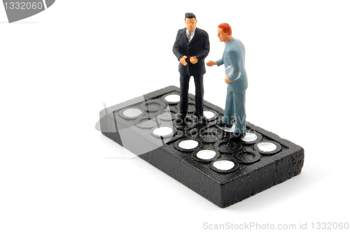 Image of business man on domino isolated