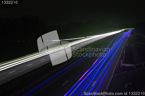 Image of road with car traffic at night with blurry lights