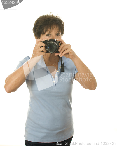 Image of middle age senior woman with camera taking photo