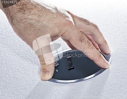 Image of Hands installing metal pot light fixture