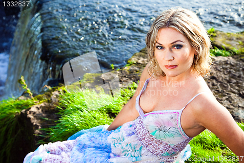 Image of Beautiful girl on brink of precipice of river waterfalls 