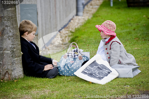Image of Two children in clothes of 50th years