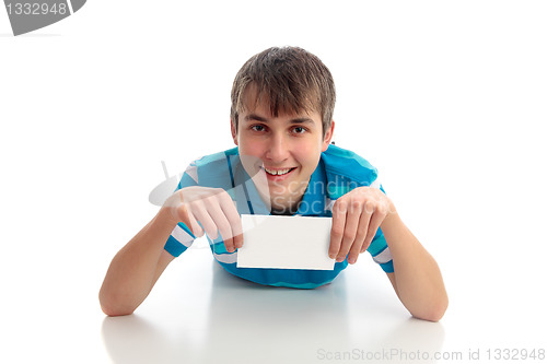 Image of Boy lying down holding small sign award etc