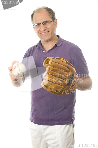 Image of   middle age senior man softball throwing into baseball glove on