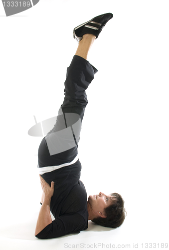 Image of middle age woman demonstrating yoga position half shoulderstand 