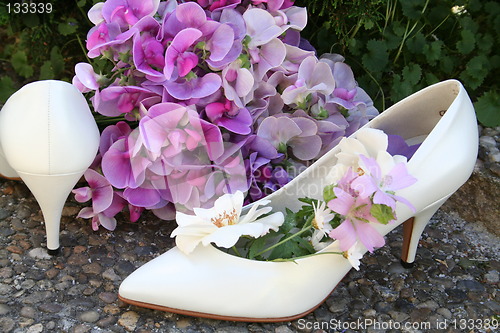 Image of White pumps and flowers