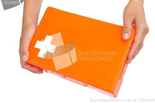 Image of Hands of young woman holding first aid kit