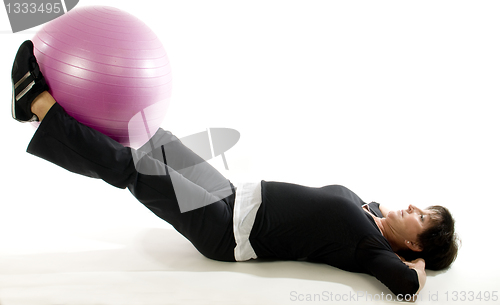 Image of middle age senior woman exercise with core training ball
