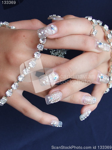 Image of decorated nails with jewelry
