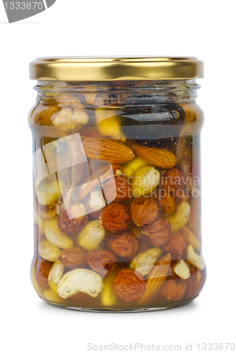 Image of Glass jar with honey, nuts and figs