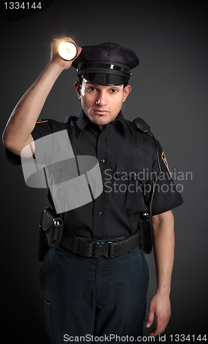 Image of Policeman or Security Guard shining a torch