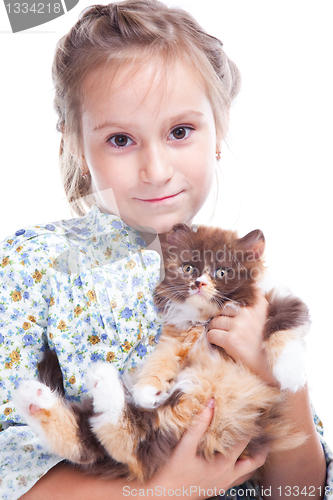 Image of girl gently embracing tortoise British kitten