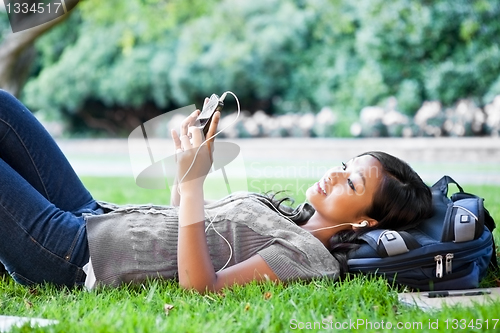 Image of Asian college student listening to music