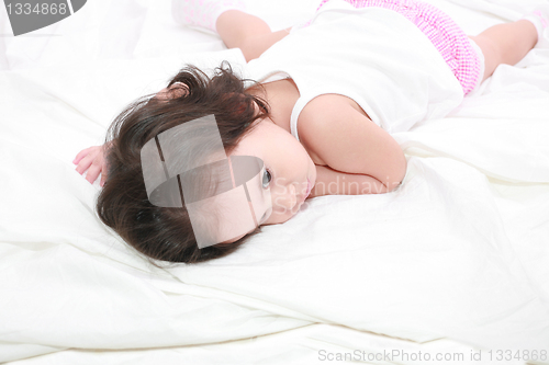 Image of adorable toddler girl on the bed at home