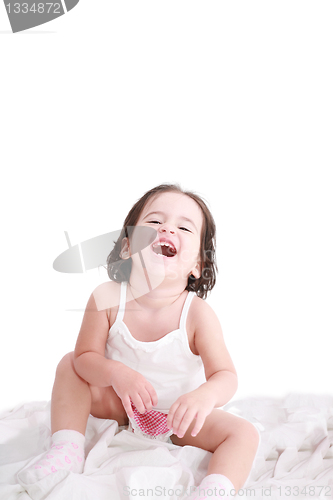 Image of laughing little girl on her bed