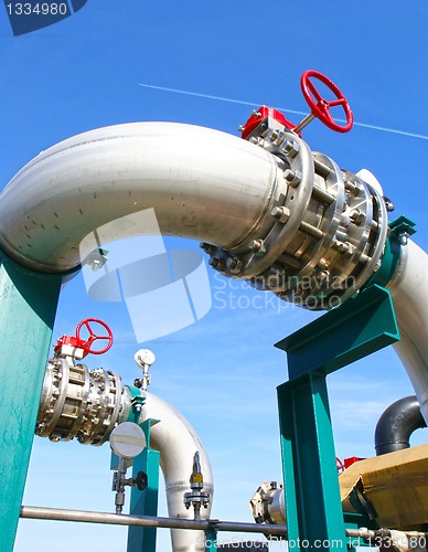 Image of Industrial zone, Steel pipelines and valves against blue sky