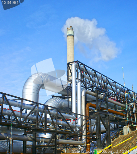 Image of Industrial zone, Steel pipelines and valves against blue sky