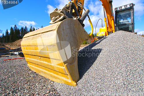 Image of excavator against blue sky    